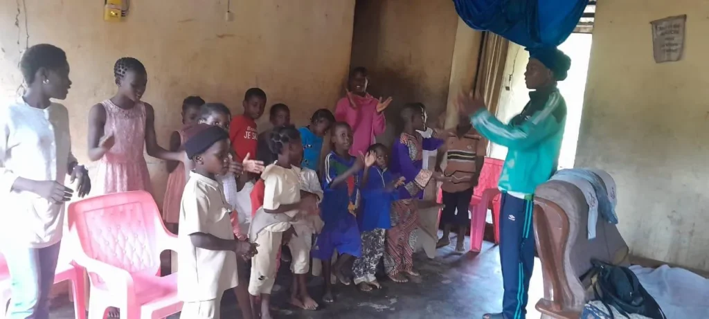 Children clapping and singing during an indoor Bible club