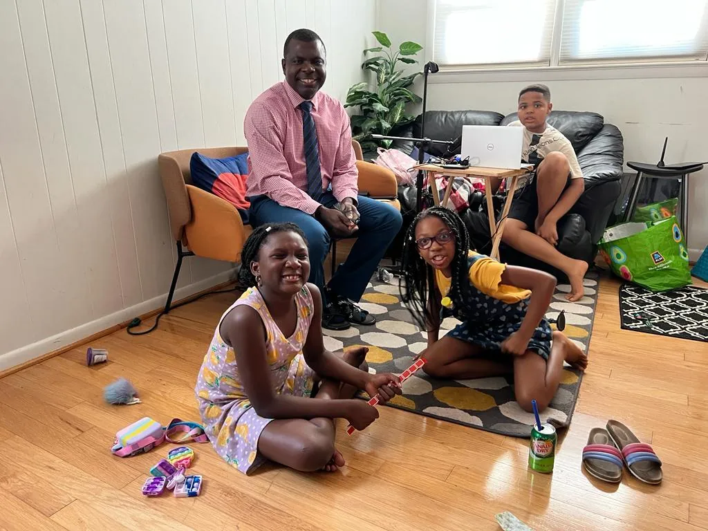 A ministry leader with children in a family living room