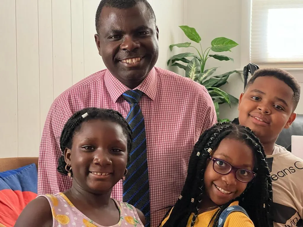 A ministry leader smiling with children
