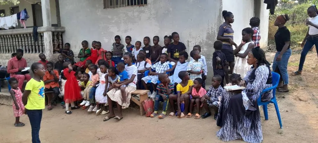 A large group of children gathered outdoors for a Bible club meeting