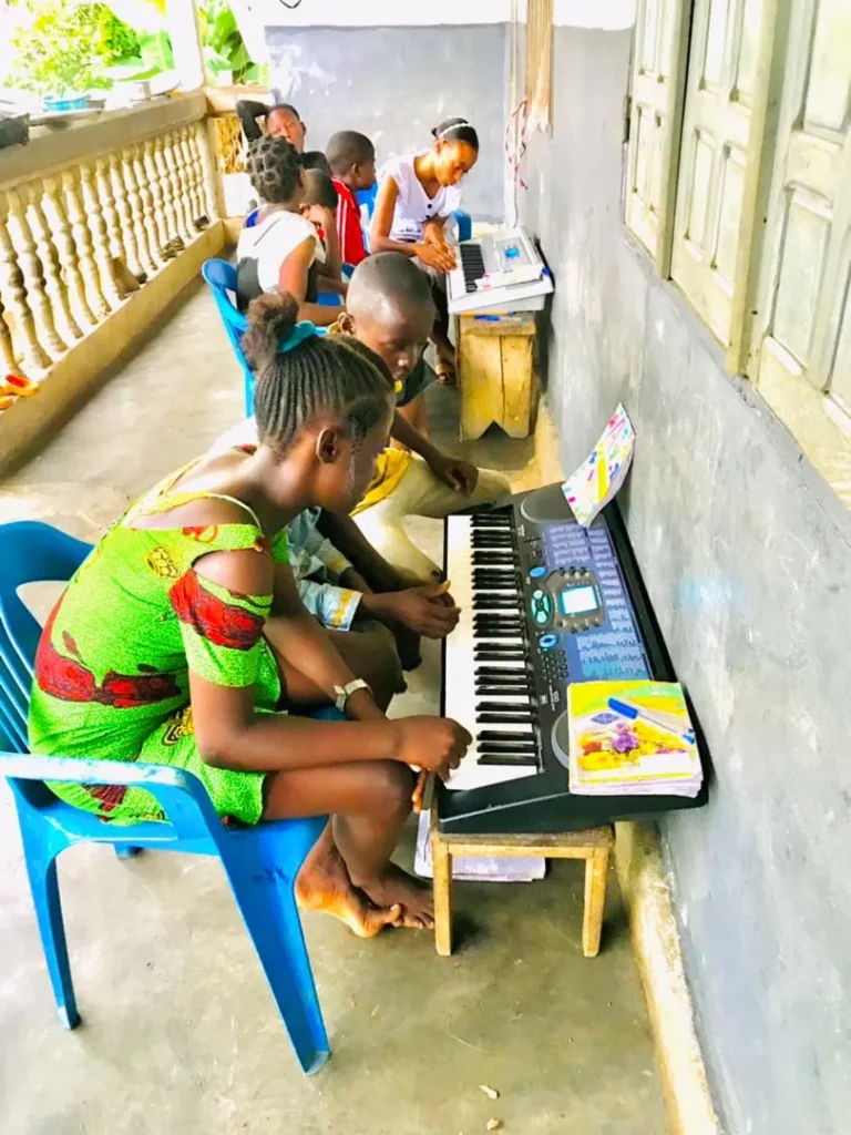 A girl practising on a keyboard during a music session